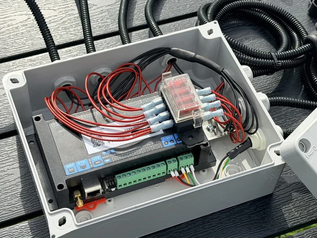 The custom build open: the 8-channel module, a blade-fuse block and the output wiring inside the enclosure