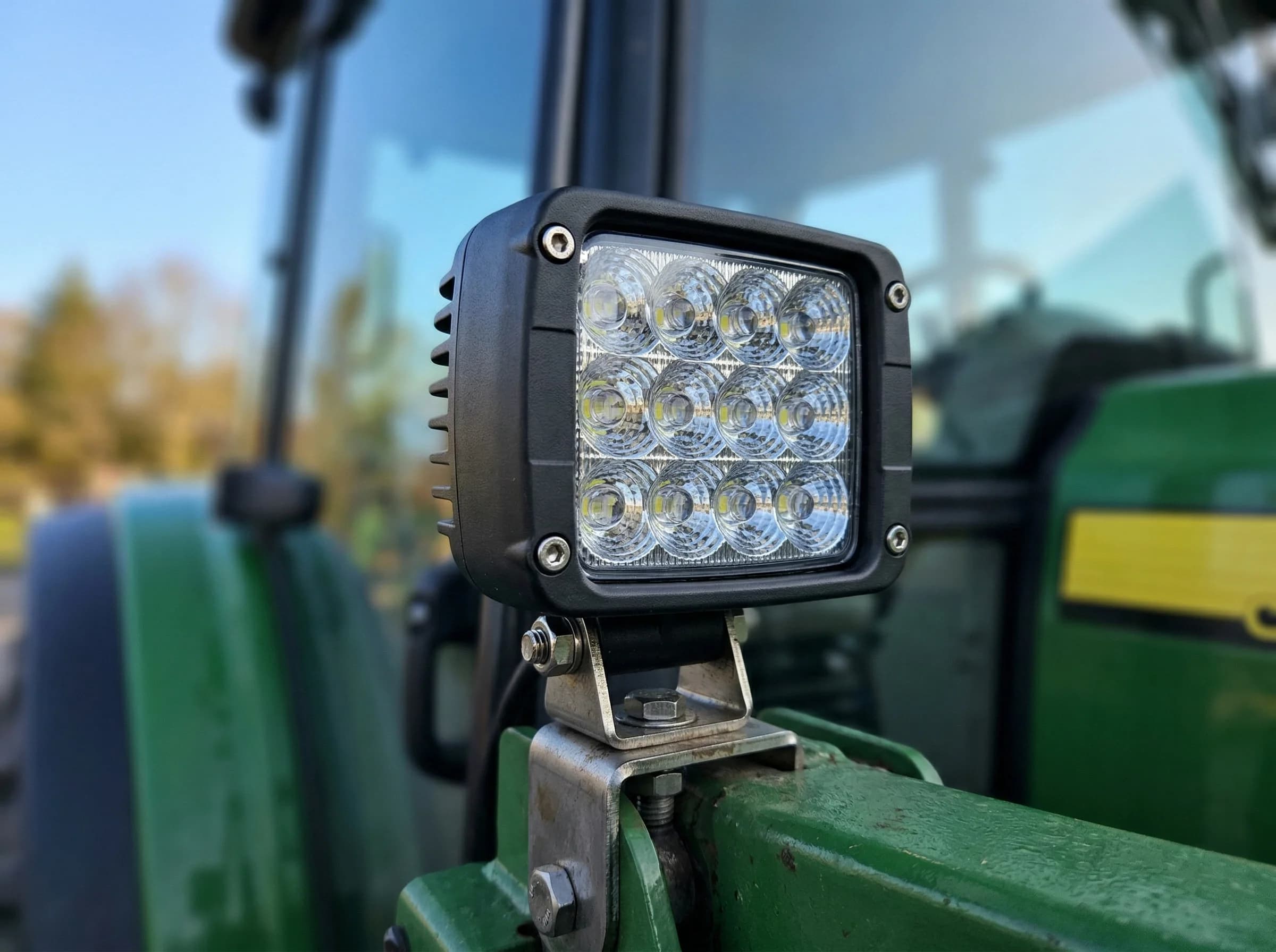 LED work light mounted on a tractor hood bracket